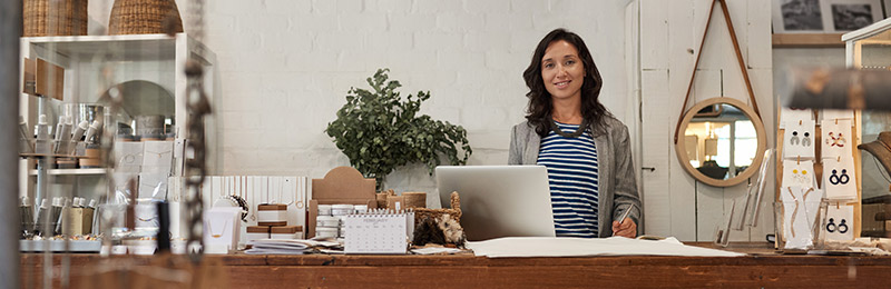 Woman smiling behind counter