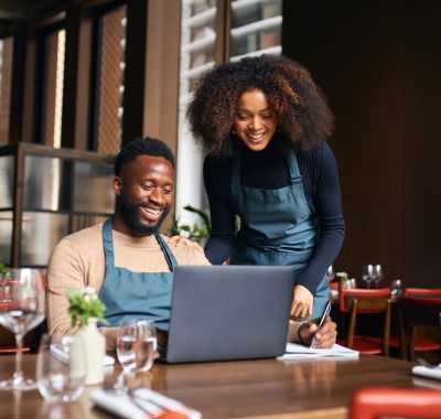 Man and woman working together on laptop