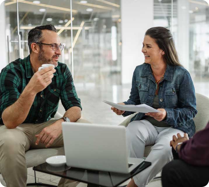 People talking around laptop