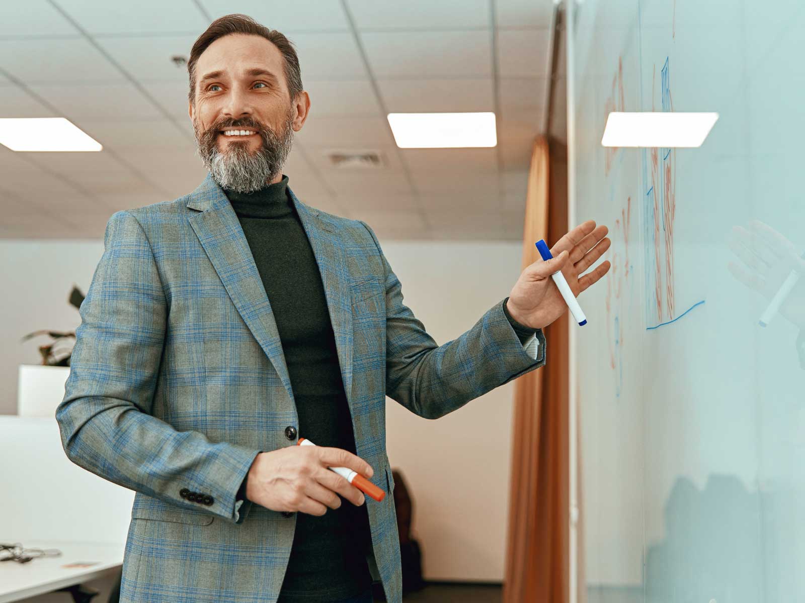 Man smiling at whiteboard