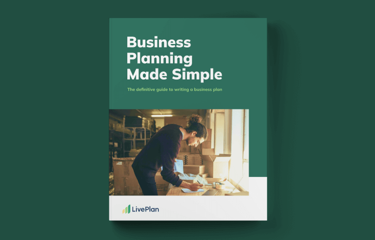 Cover of "Business Planning Made Simple" by LivePlan, featuring a person writing at a desk in a well-lit room.